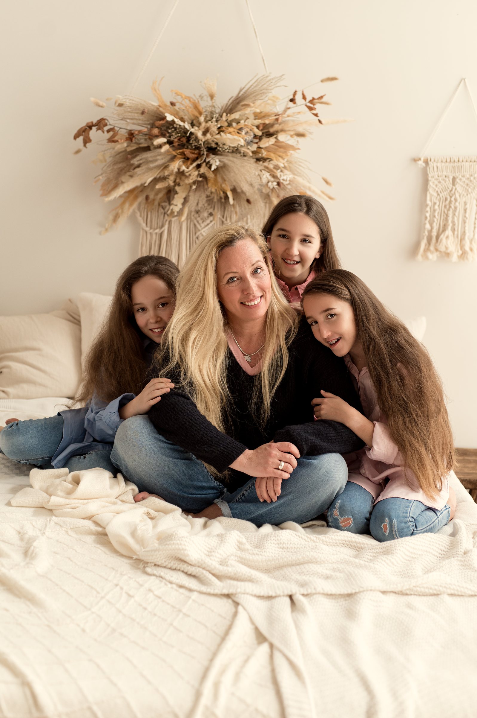 Mama mit ihren drei Töchtern auf dem Studio-Bett
